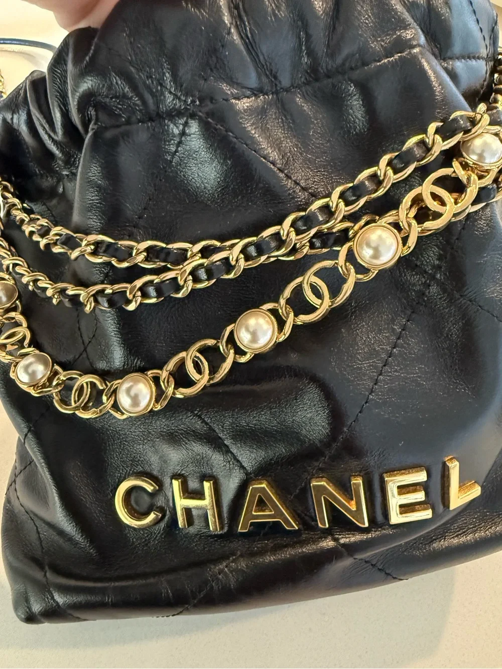 CHANEL 22 Black Quilted Leather Crossbody with Pearl-Trim Chain